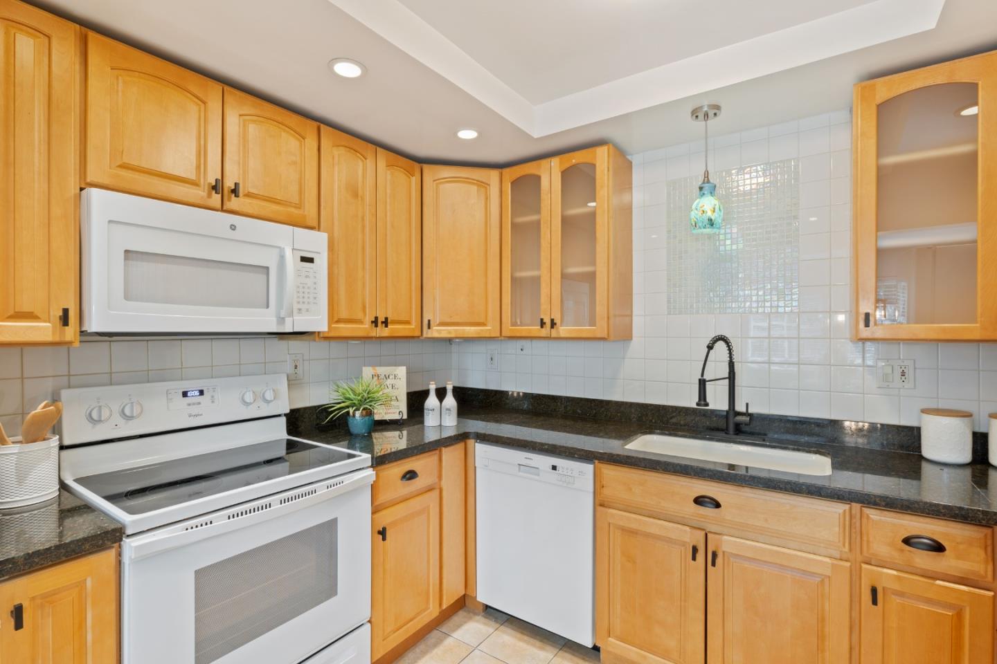 1148 Kayellen Court San Jose, CA 95125 - Photo 8 of 23 a kitchen with granite countertop cabinets sink and stainless steel appliances