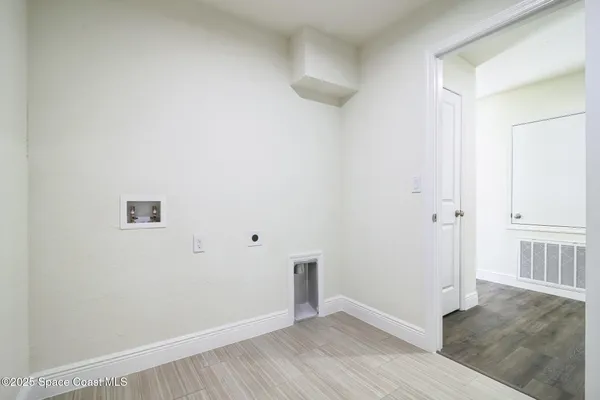 an empty room with wooden floor and window