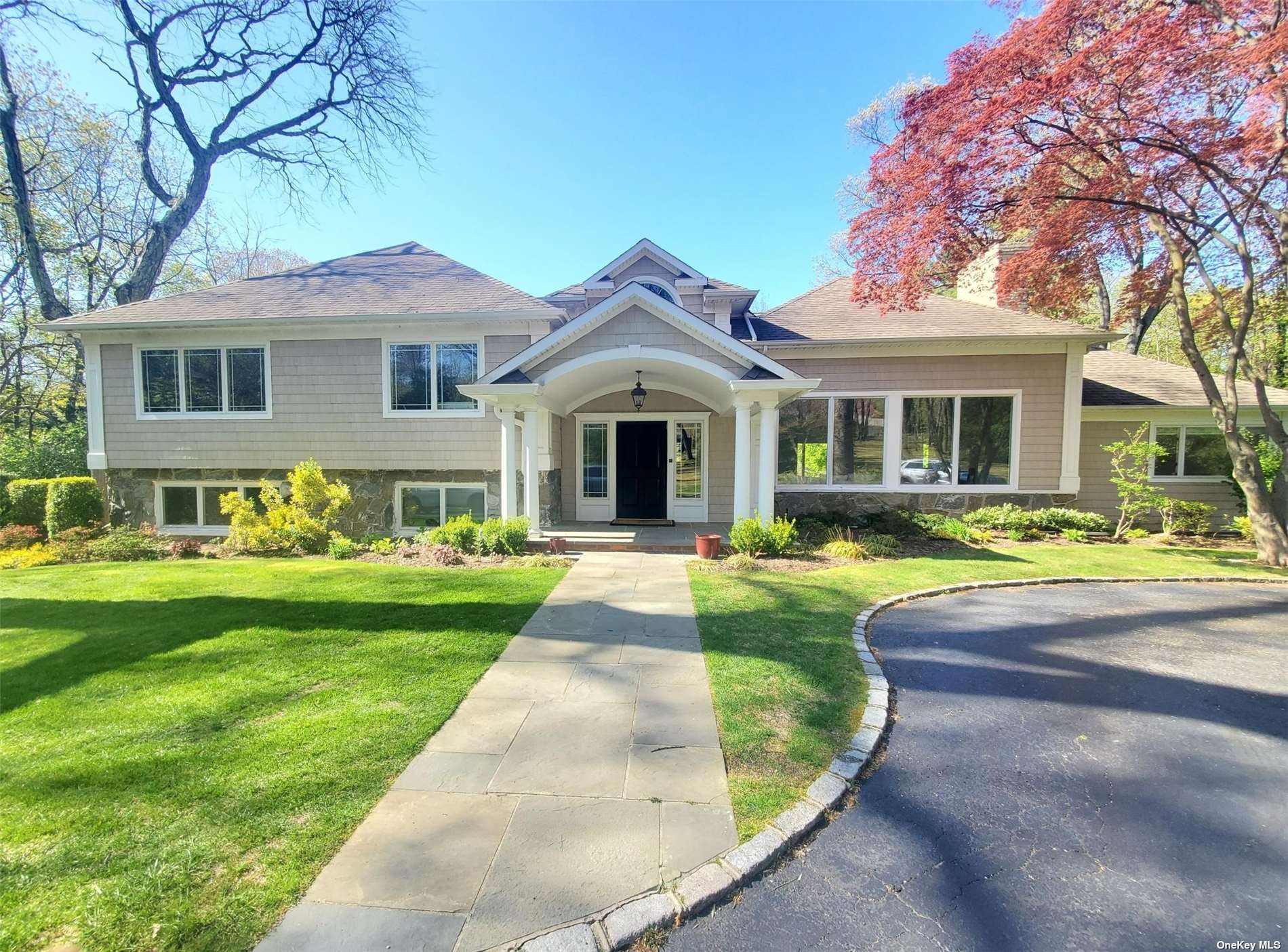 179 Harbor Acres Road Sands Point, NY 11050 - Photo 1 of 1 a front view of a house with yard and green space