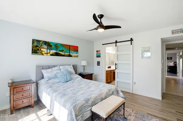 a bedroom with a bed and a chandelier