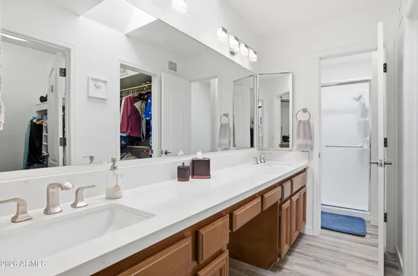 a bathroom with a granite countertop toilet and a shower