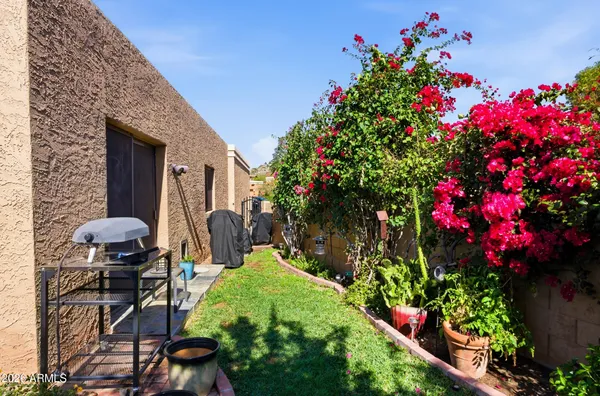 a view of a house with backyard water fountain and sitting area