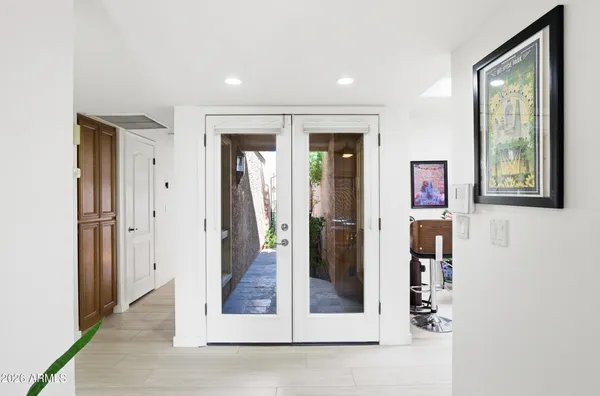 a living room with furniture large window and a flat screen tv