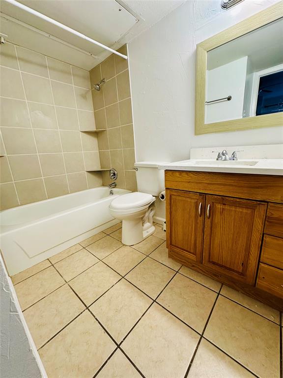 2240 Tarpley Road, Unit 234 Carrollton, TX 75006 - Photo 11 of 13 a bathroom with a sink a toilet and shower
