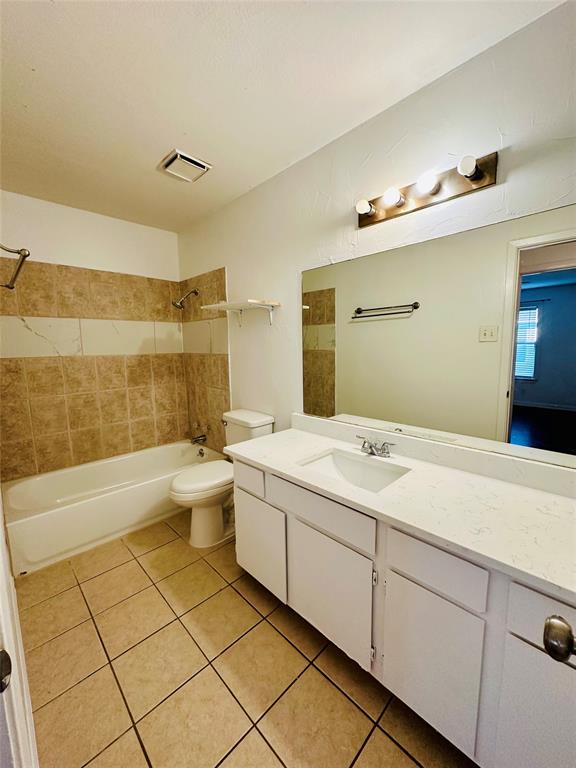 2240 Tarpley Road, Unit 234 Carrollton, TX 75006 - Photo 12 of 13 a spacious bathroom with a granite countertop sink a toilet a mirror and bathtub