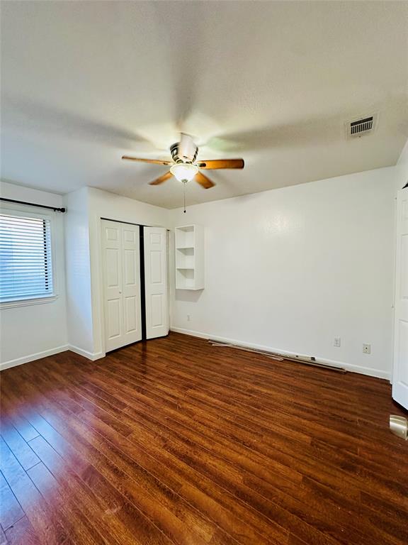 2240 Tarpley Road, Unit 234 Carrollton, TX 75006 - Photo 10 of 13 a view of an empty room with wooden floor and a ceiling fan