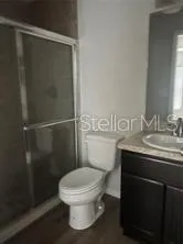 a bathroom with a toilet a sink and shower