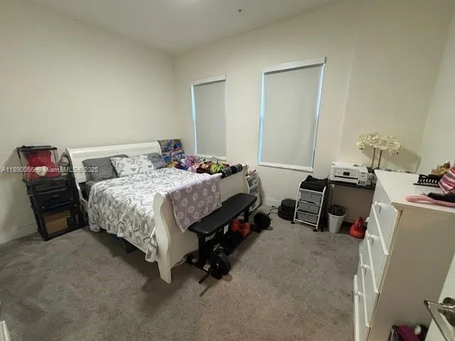 a bedroom with a bed and a furniture
