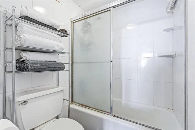 a bathroom with a shower a toilet and a shower