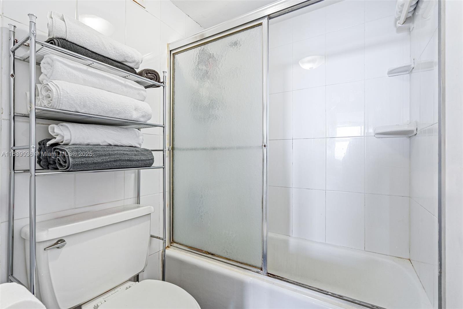 2899 Collins Avenue, Unit 931 Miami Beach, FL 33140 - Photo 11 of 28 a bathroom with a shower a toilet and a shower