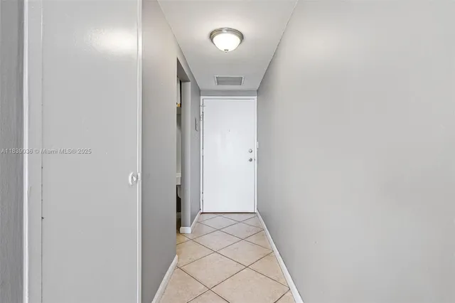 a kitchen with stainless steel appliances granite countertop a refrigerator and a stove