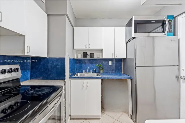 a bathroom with a granite countertop sink and shower