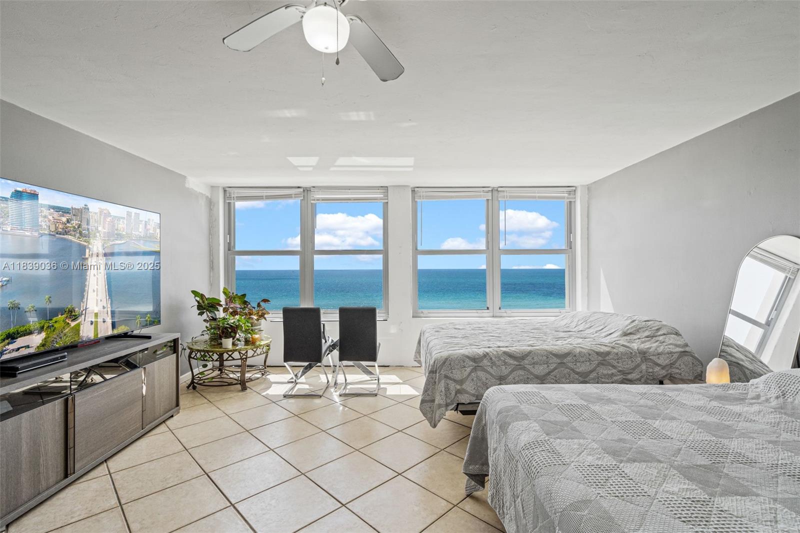 2899 Collins Avenue, Unit 931 Miami Beach, FL 33140 - Photo 3 of 28 a large bedroom with a bed and large window