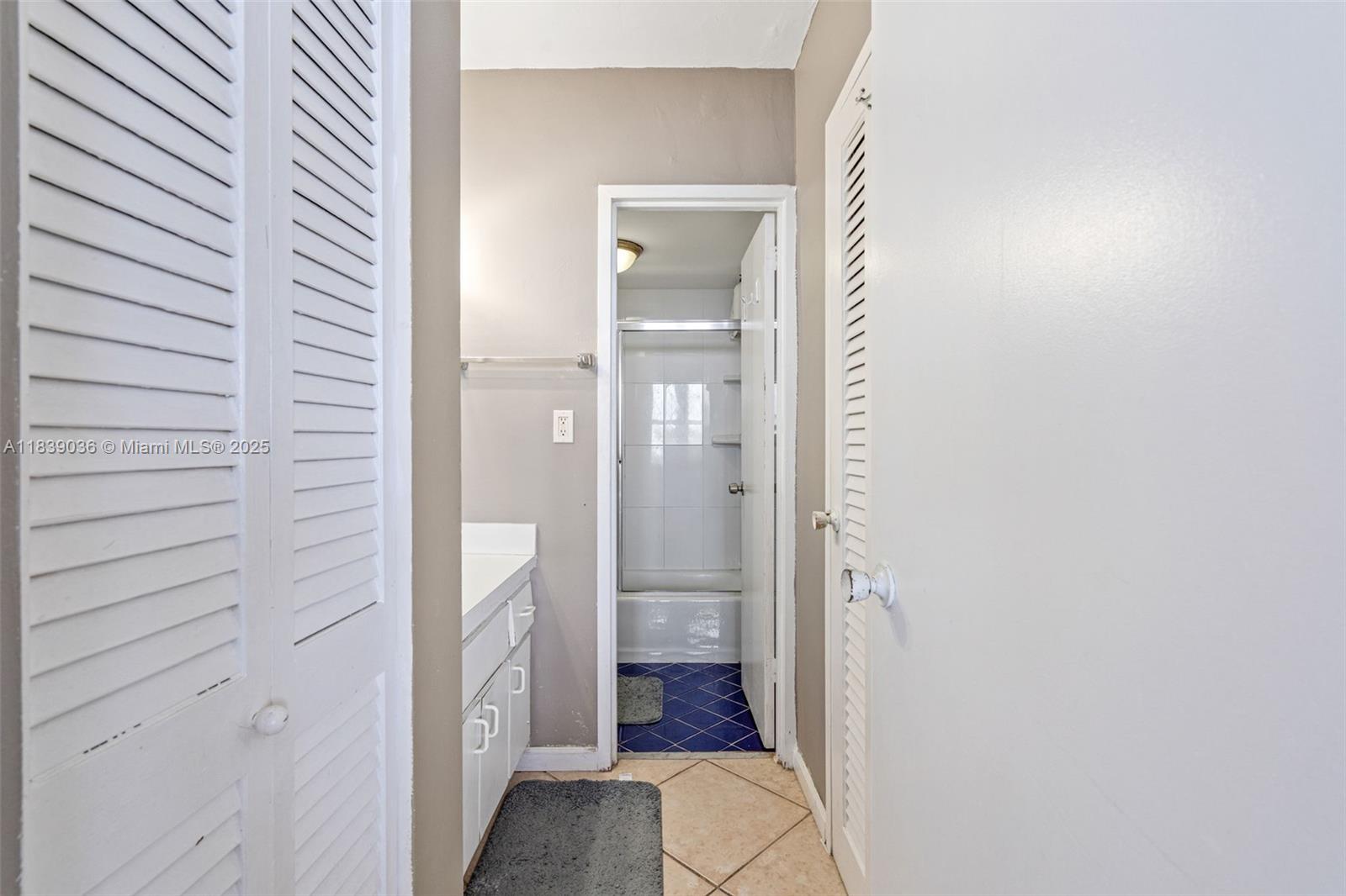 2899 Collins Avenue, Unit 931 Miami Beach, FL 33140 - Photo 9 of 28 a bathroom with a vanity and a shower