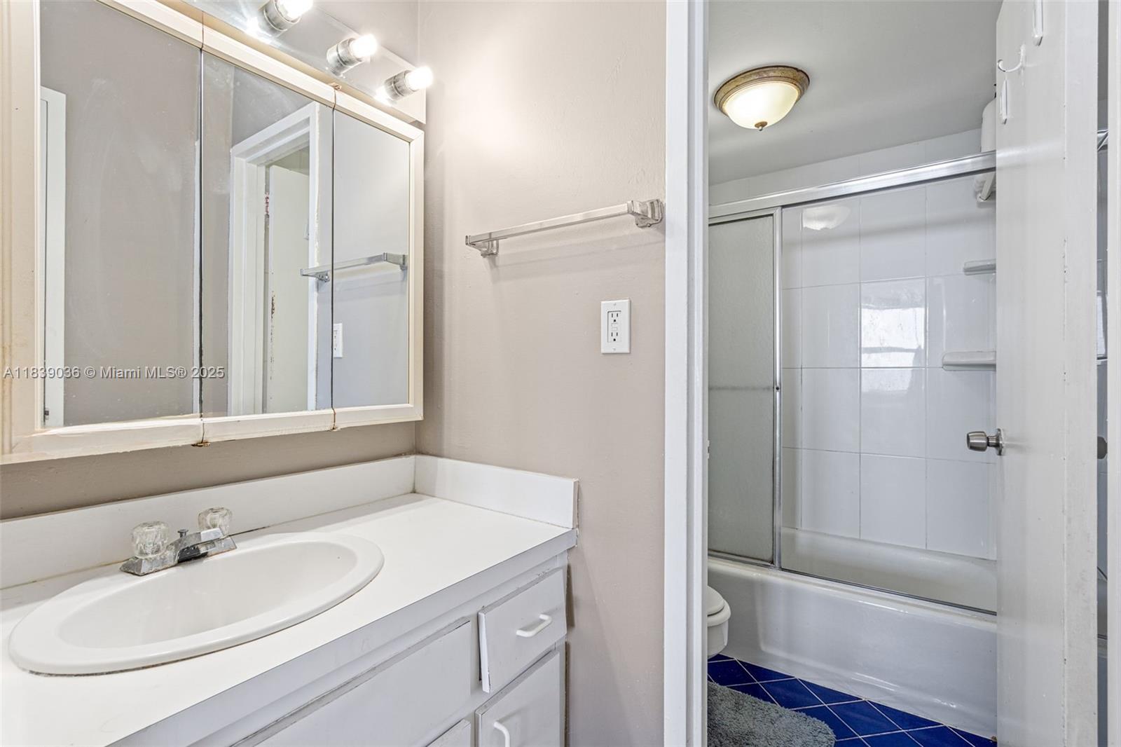 2899 Collins Avenue, Unit 931 Miami Beach, FL 33140 - Photo 10 of 28 a bathroom with a sink a toilet and shower