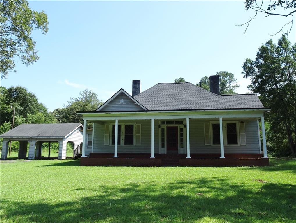 11869 Brown Bridge Road Covington, GA 30016 - Photo 1 of 1 a front view of a house with a garden