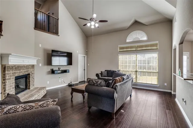 a living room with furniture a fireplace and a flat screen tv