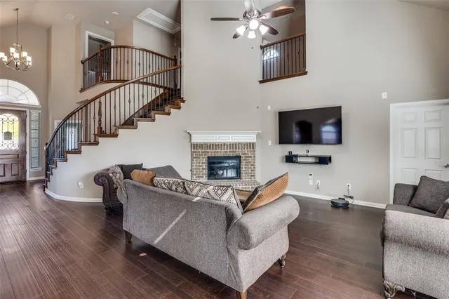 a living room with fireplace furniture and a flat screen tv