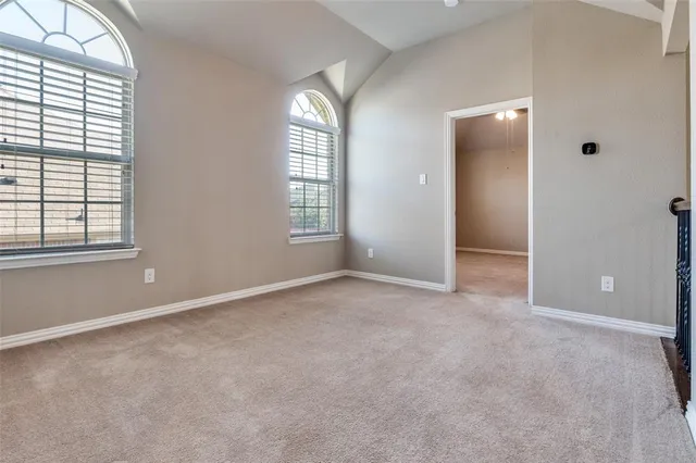 an empty room with windows and closet area