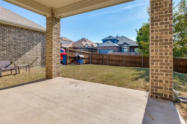 a view of a house with a backyard and a garage