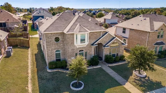 an aerial view of a house with a yard