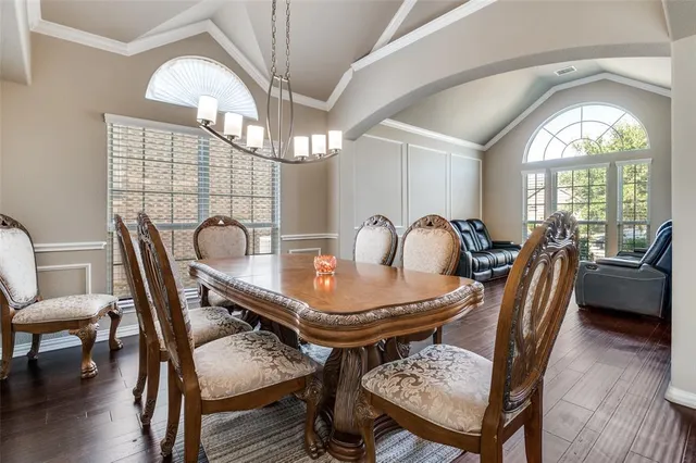 a view of a dining room with furniture and chandelier