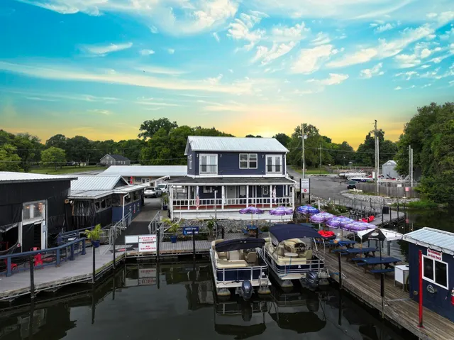 a view of a patio with table and chairs and potted plants