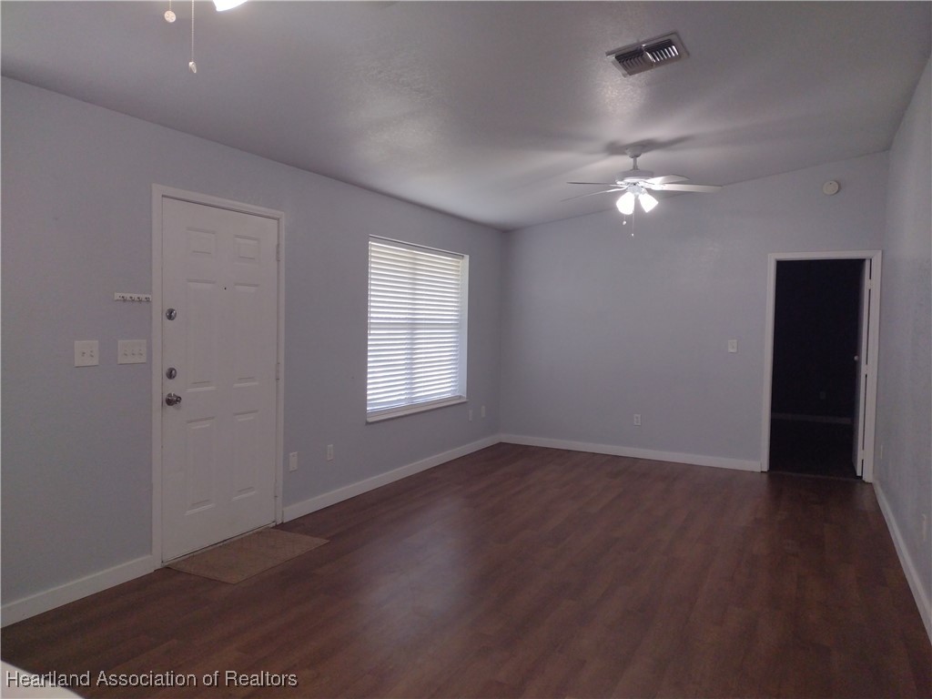 1731 West Batavia Road Avon Park, FL 33825 - Photo 19 of 25 an empty room with wooden floor closet fan and windows