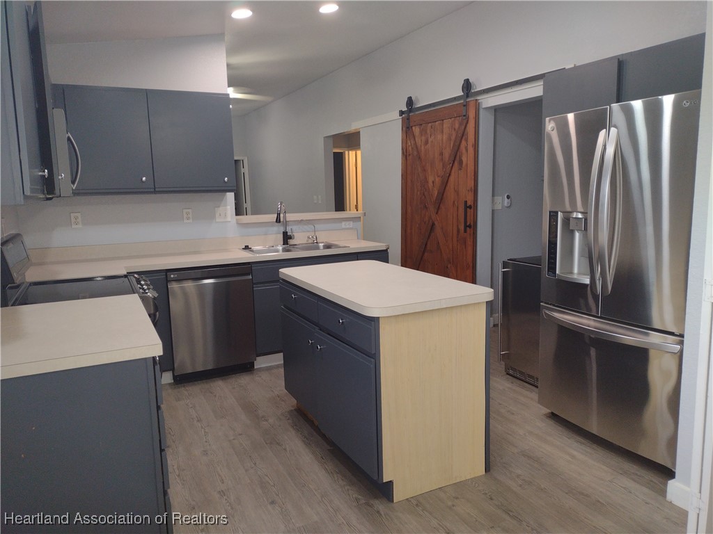 1731 West Batavia Road Avon Park, FL 33825 - Photo 21 of 25 a kitchen with a sink refrigerator and cabinets