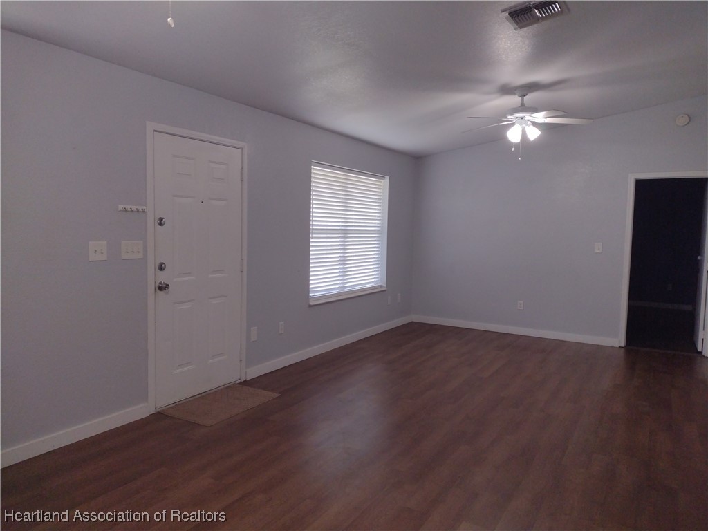 1731 West Batavia Road Avon Park, FL 33825 - Photo 3 of 25 wooden floor in an empty room with a window