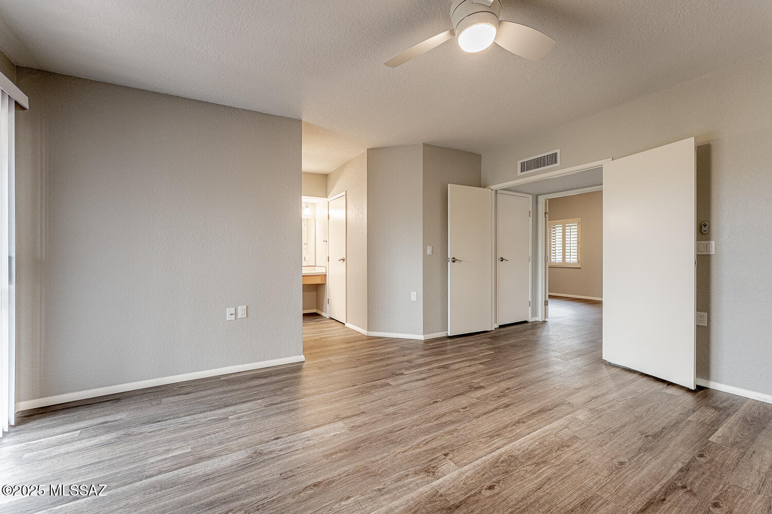 931 West Rio Guaymas Green Valley, AZ 85614 - Photo 25 of 39 a view of an empty room with wooden floor and a window