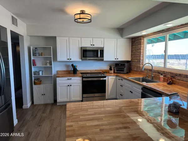 a kitchen with stainless steel appliances a stove sink and refrigerator