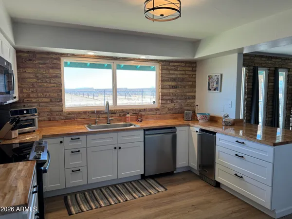 a kitchen with granite countertop a sink cabinets and window