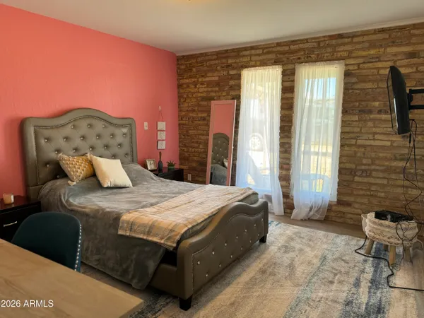 a bedroom with a bed and a painting on the wall