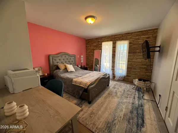 a bedroom with a bed and a potted plant