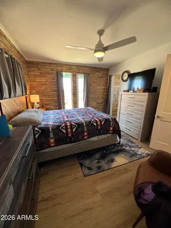 a bed sitting in a bedroom next to a window