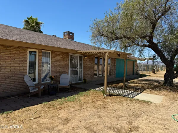a view of a house with a yard and wooden fence
