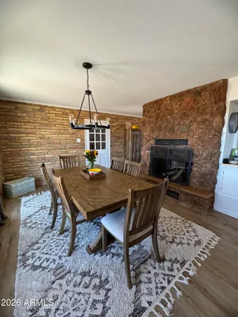 a dining room with furniture a rug and wooden floor