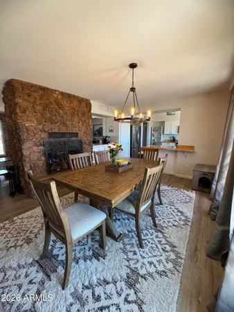 a view of a roof deck with dining table and chairs
