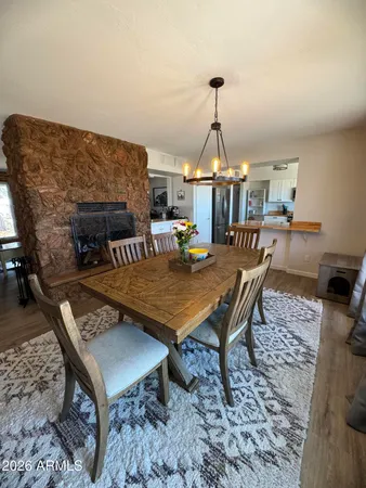 a dining room with furniture a rug and a chandelier