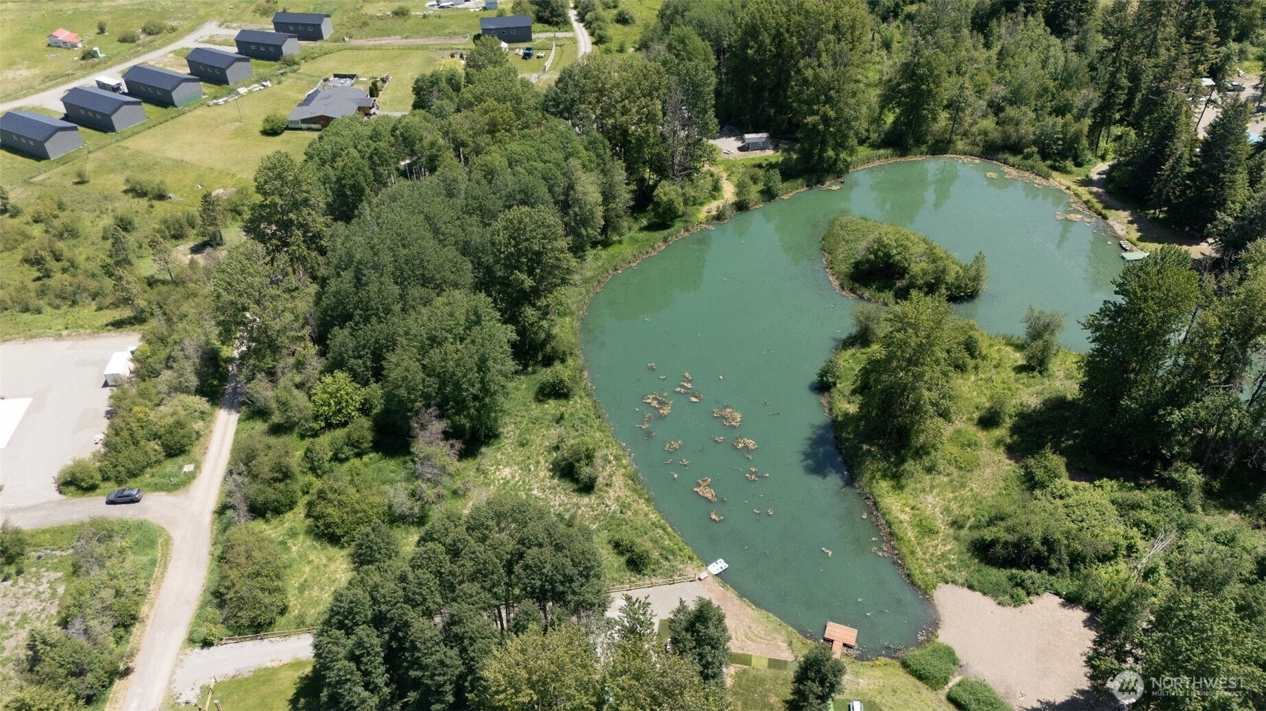 an aerial view of a house with a yard and lake view