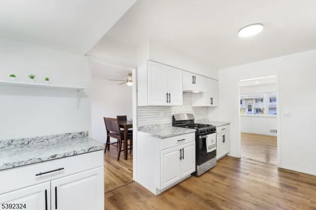 a kitchen with a stove top oven and cabinets