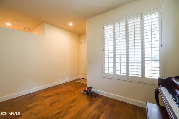 a bedroom with a bed and a painting on the wall