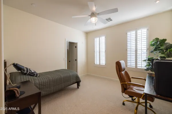 a view of a backyard with a small cabin and wooden fence