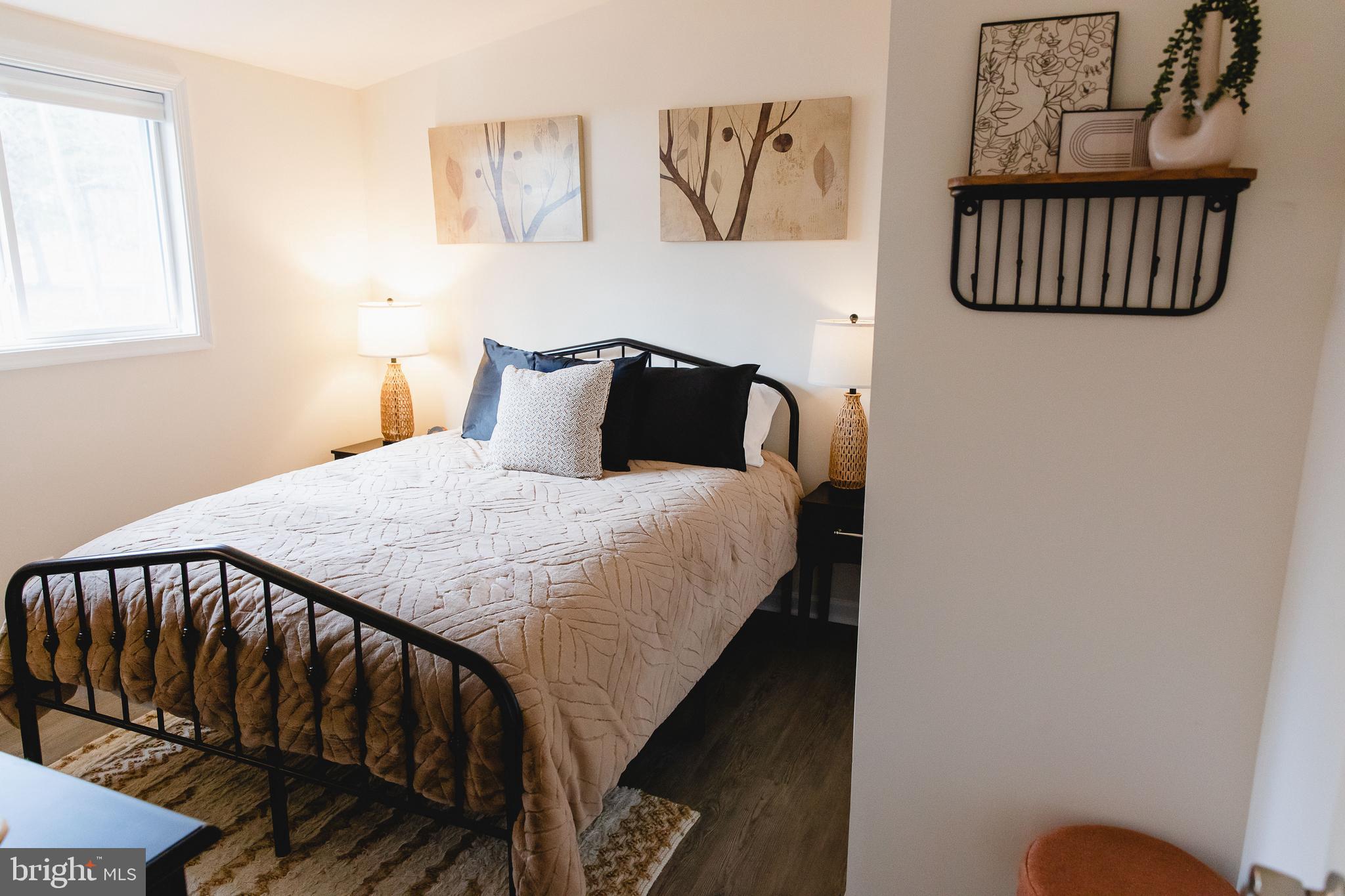 331 Walden Road Hedgesville, WV 25427 - Photo 18 of 30 a bedroom with a bed and painting on the wall