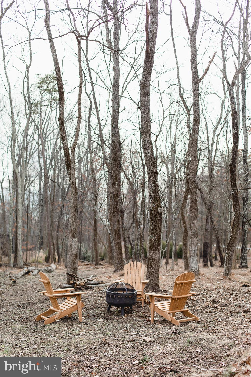 331 Walden Road Hedgesville, WV 25427 - Photo 29 of 30 a backyard of a house with large trees and wooden fence
