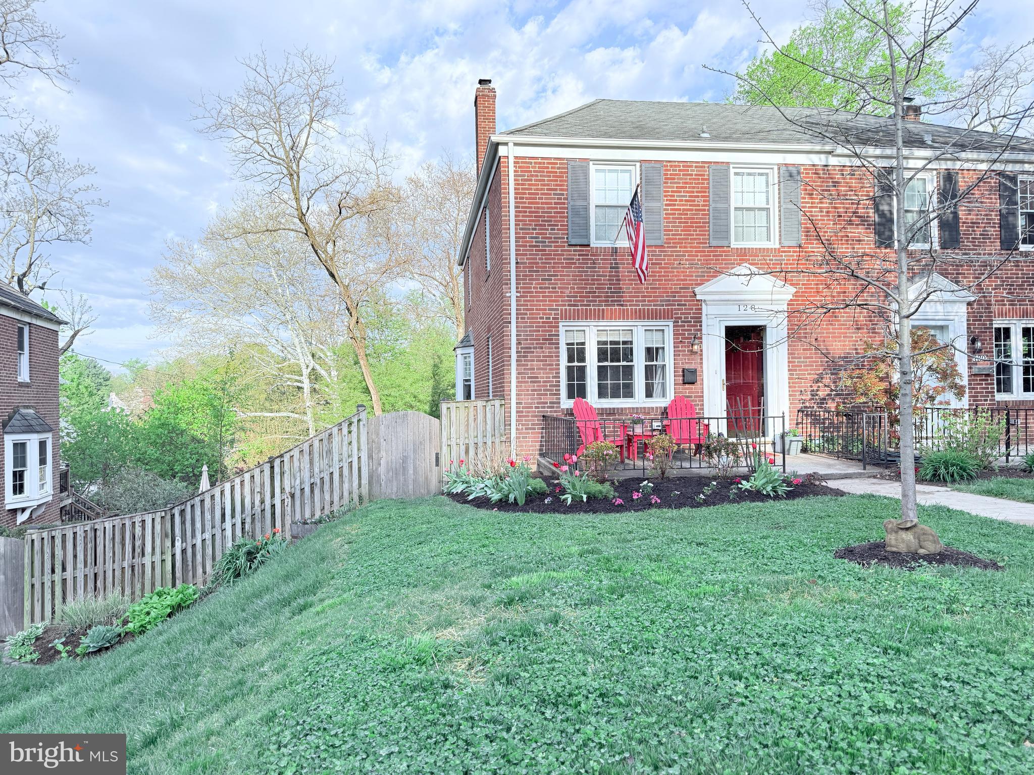 128 Stanmore Road Baltimore, MD 21212 - Photo 2 of 2 a view of a brick house with a yard and plants