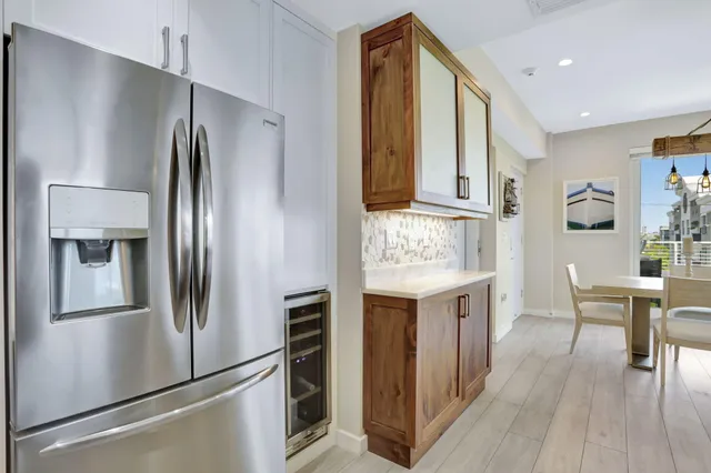 a kitchen with stainless steel appliances granite countertop a refrigerator and a stove top oven