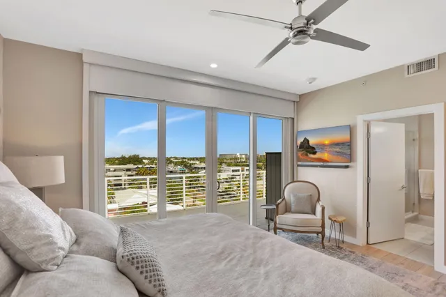 a living room with furniture and a floor to ceiling window