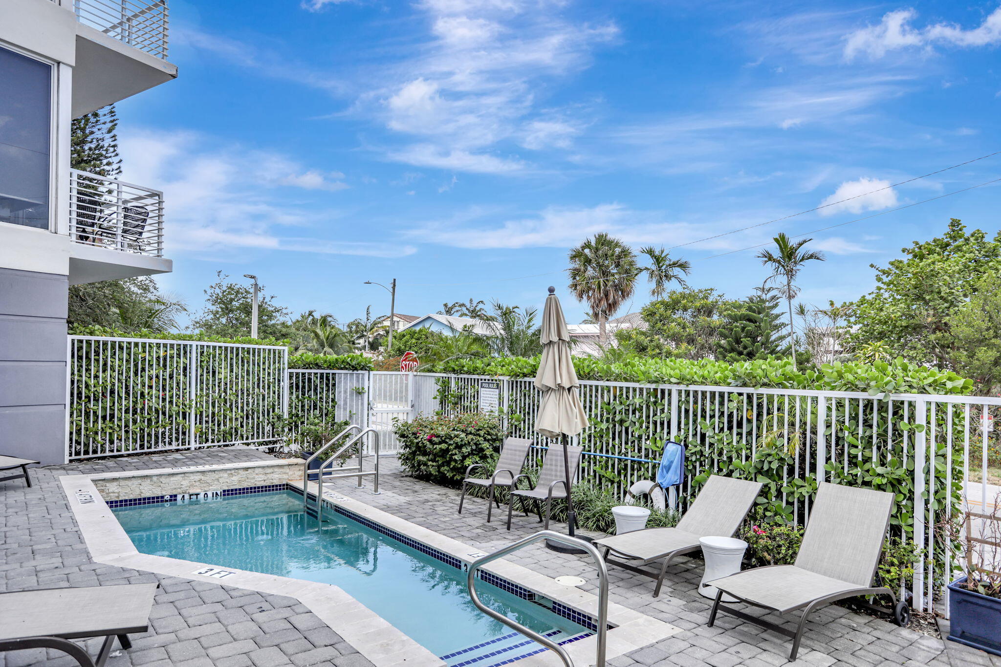1900 Southeast 2nd Street, Unit 501 Deerfield Beach, FL 33441 - Photo 2 of 41 a balcony with wooden floor table and chairs